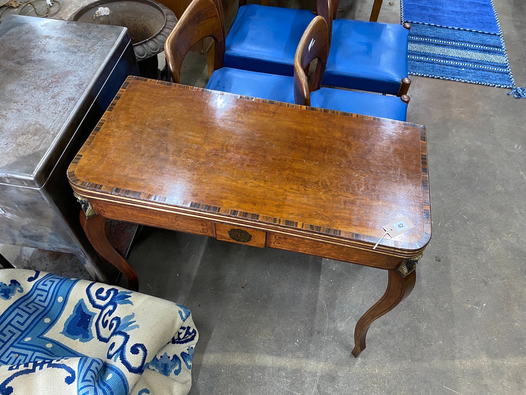 A Regency coromandel banded mahogany folding card table with parcel gilt Egyptianesque metal mounts, width 90cm, depth 44cm, height 75cm